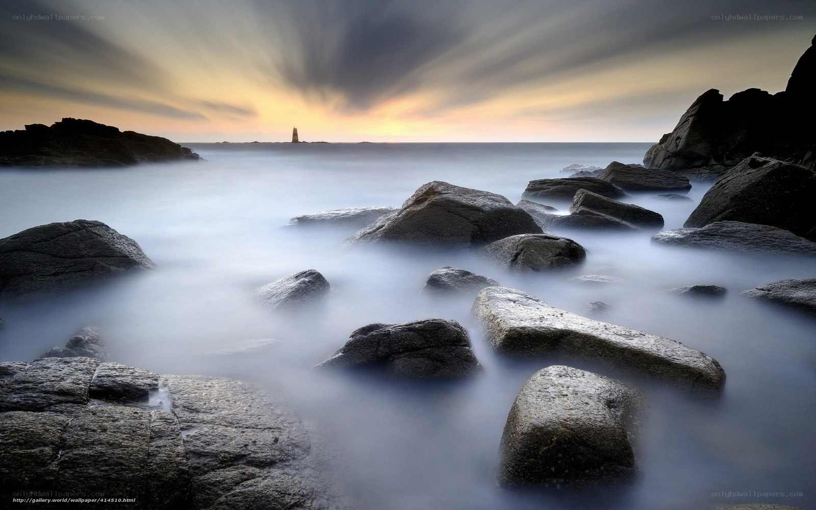 Lighthouse at coastal sunset
