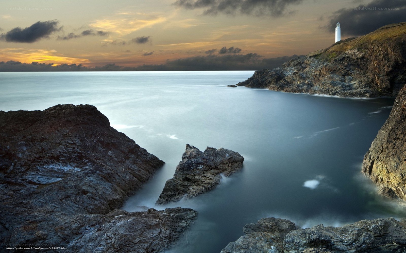 Lighthouse at coastal sunset
