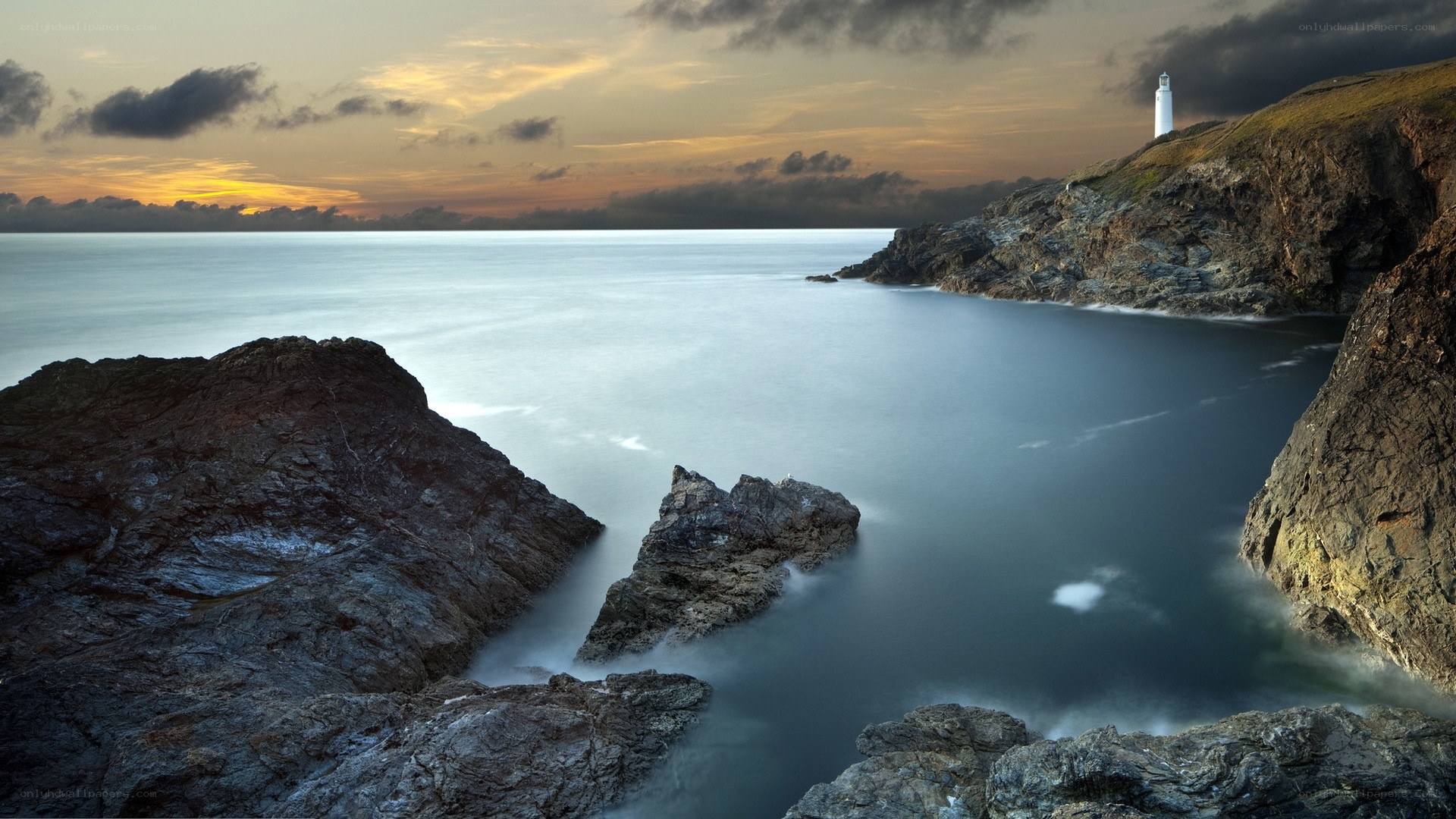 lighthouse at coastal sunset