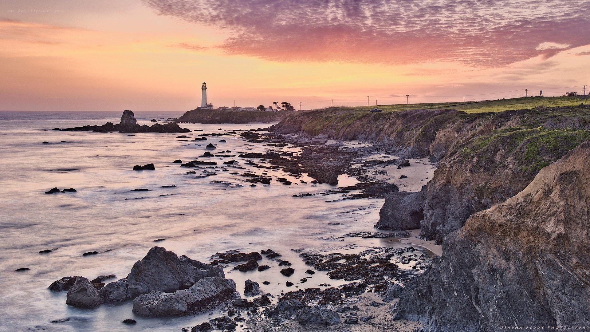 Lighthouse at coastal sunset