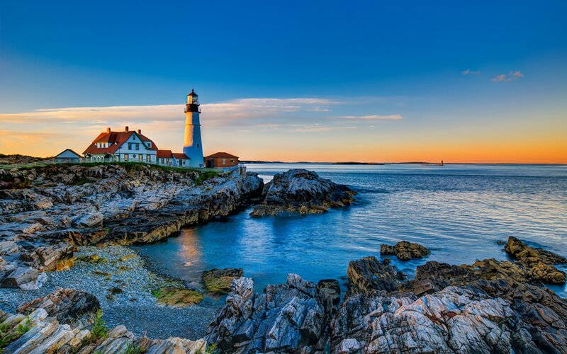 Lighthouse at coastal sunset
