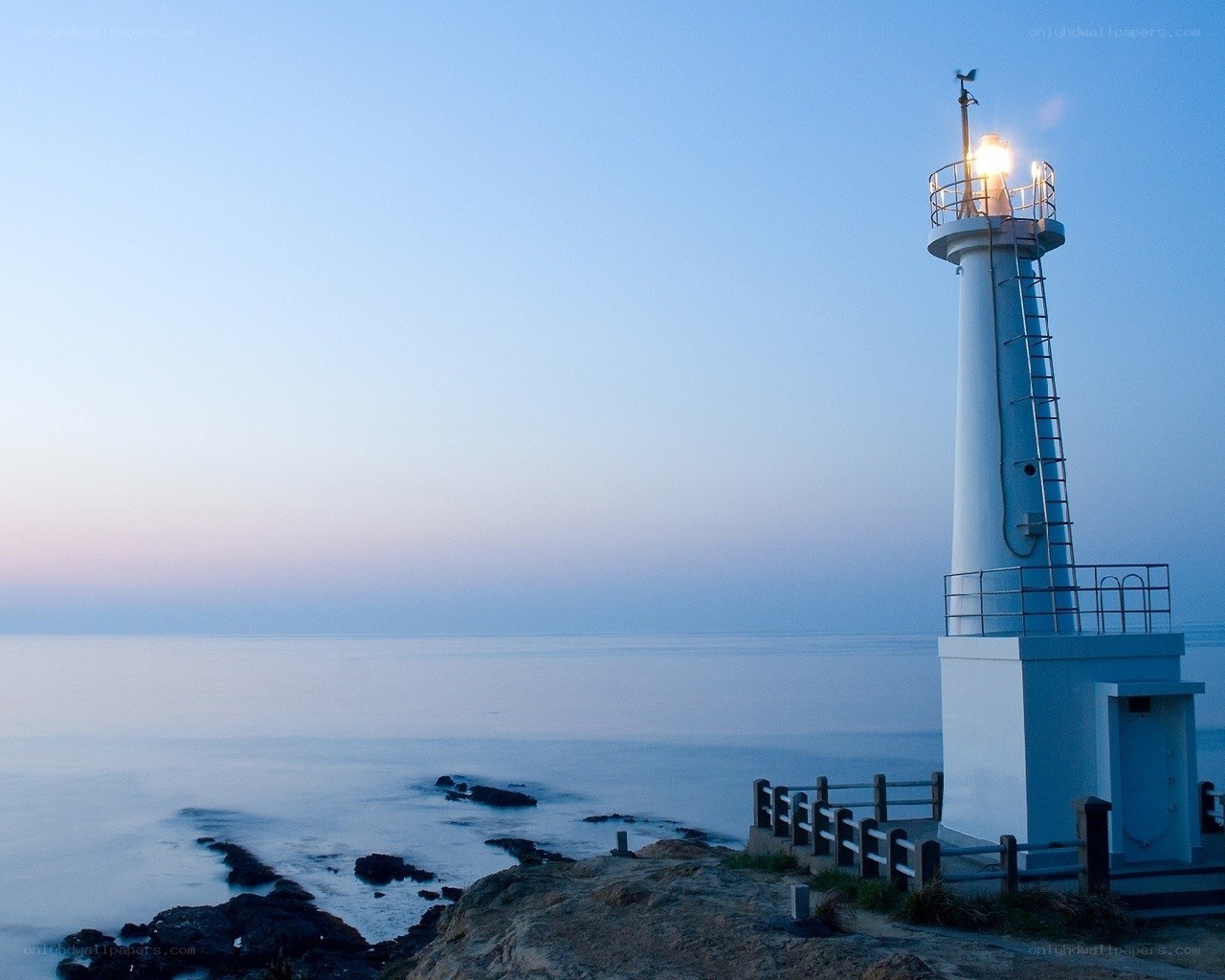Lighthouse at dawn by the sea