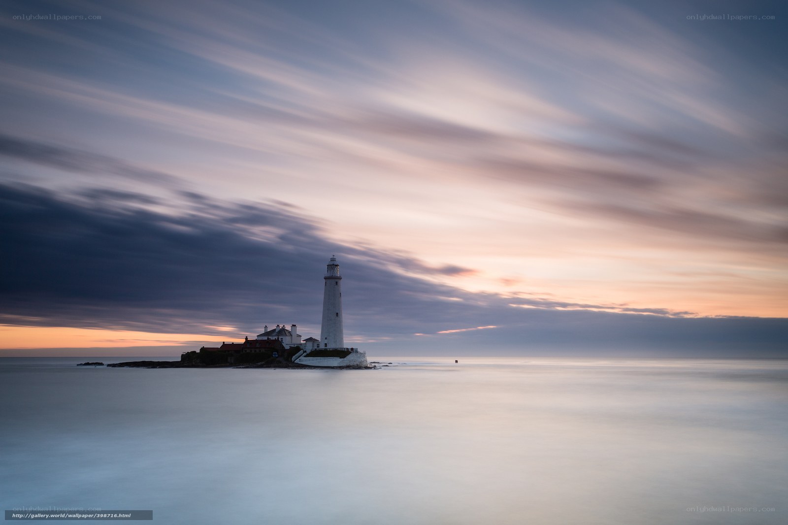 Lighthouse at dawn on a calm sea