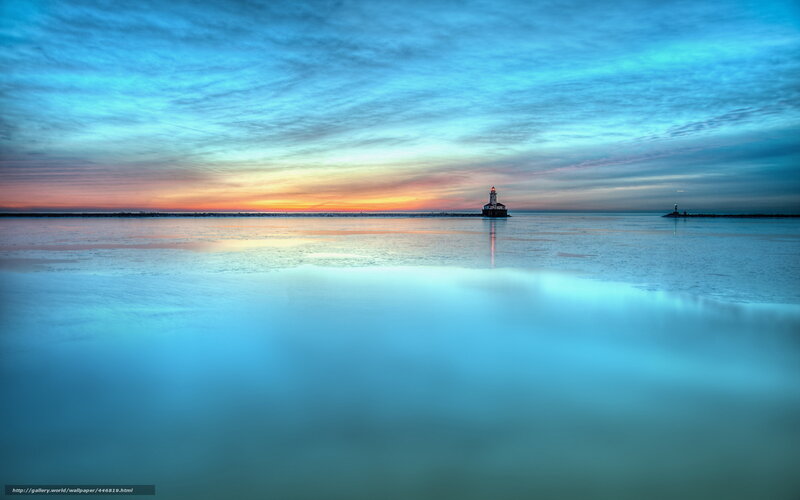 Lighthouse at dawn on frozen lake