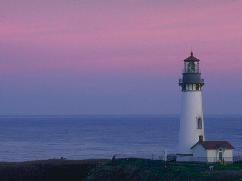 lighthouse at dusk by the ocean