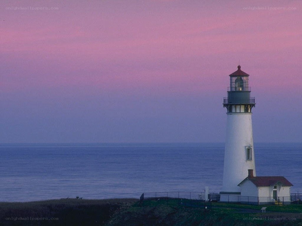 lighthouse at dusk by the ocean