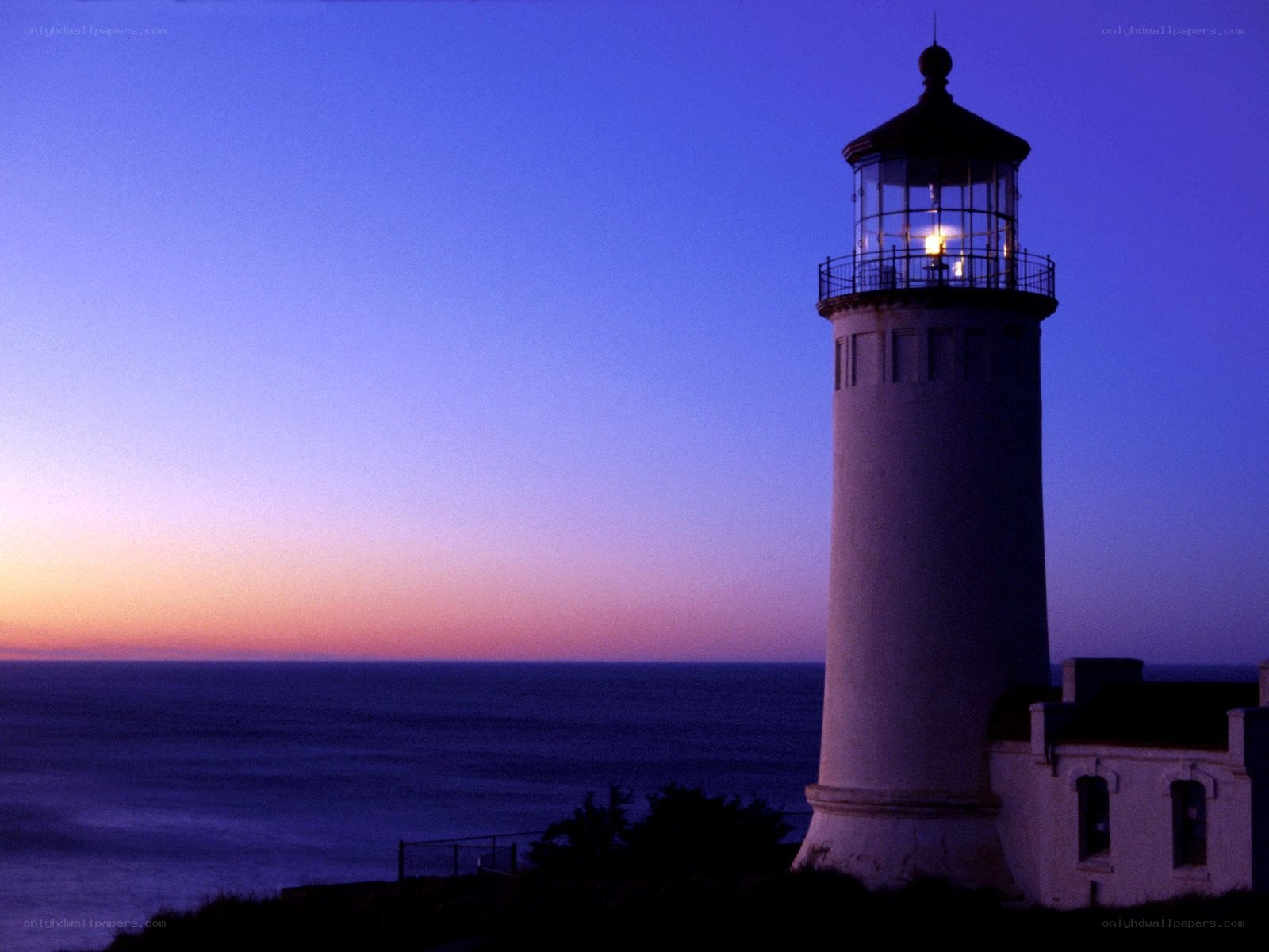 lighthouse at dusk by the ocean