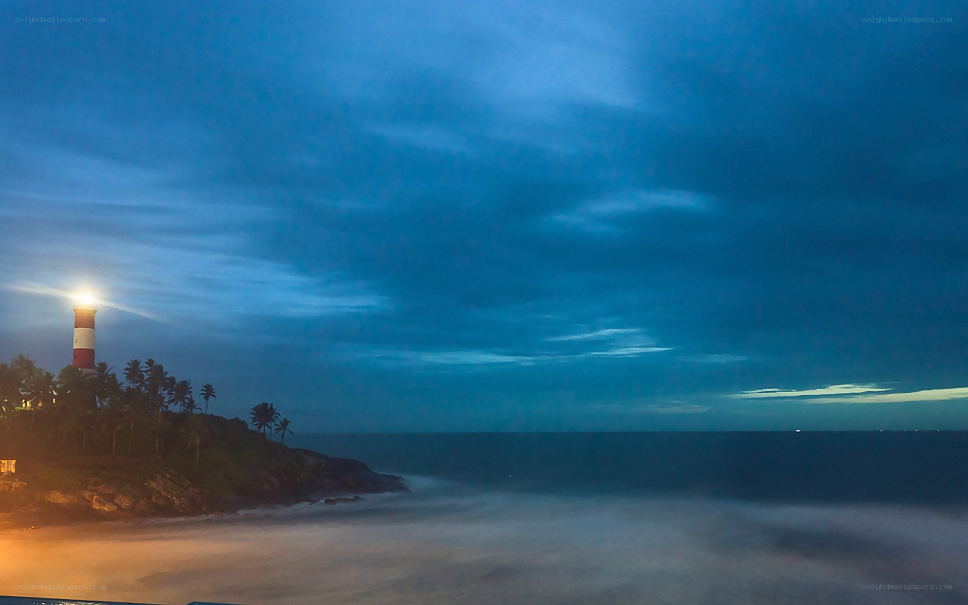 Lighthouse at dusk by the sea