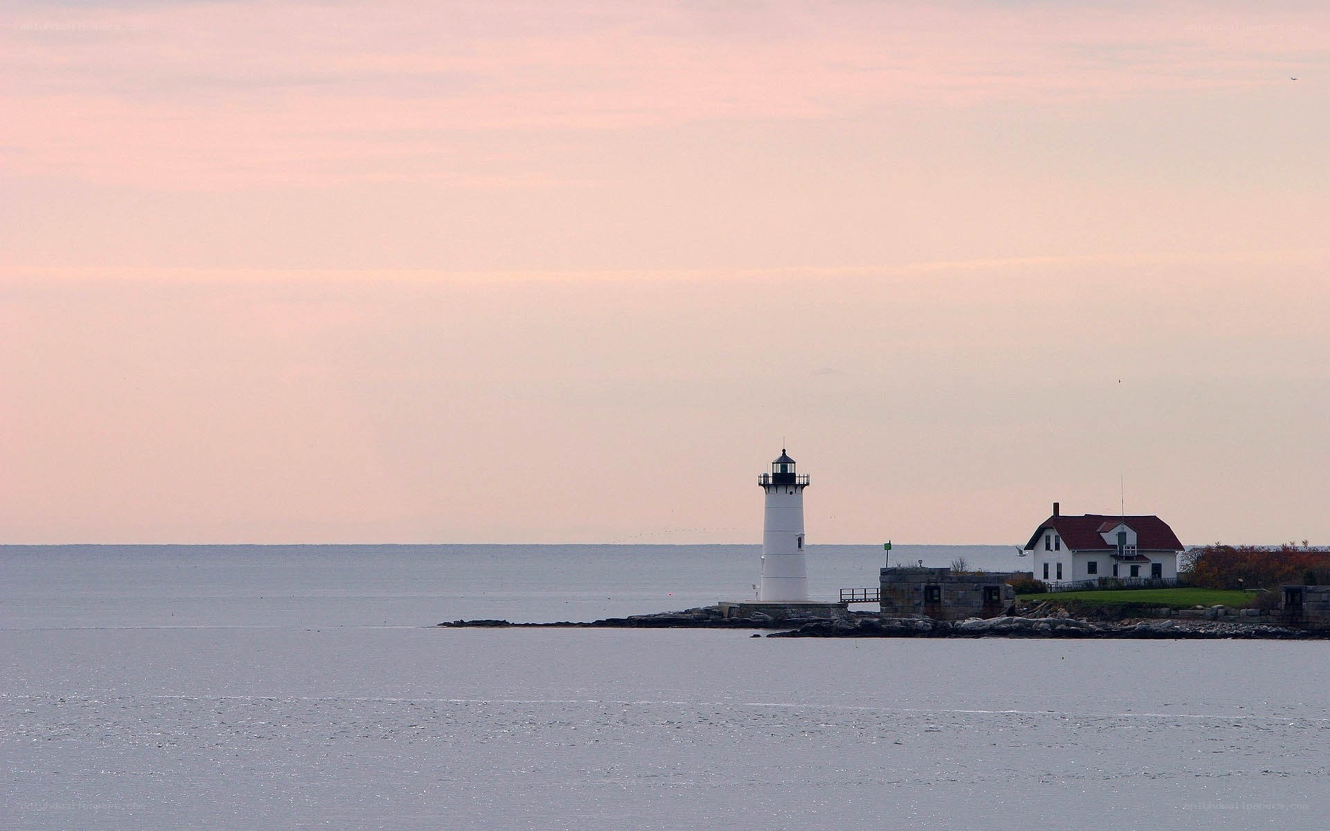 lighthouse at dusk by the sea