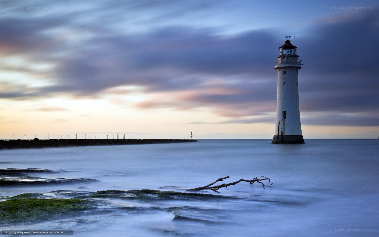 Lighthouse at dusk by the sea