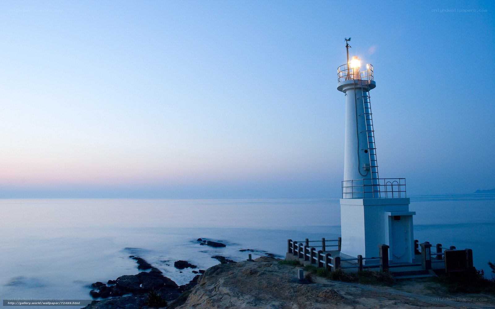 Lighthouse at dusk by the sea