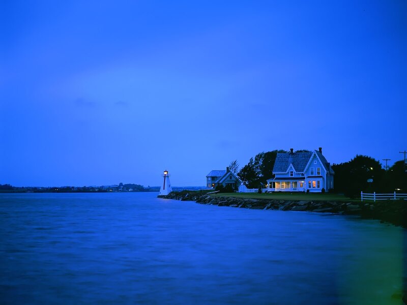 Lighthouse at dusk by the water