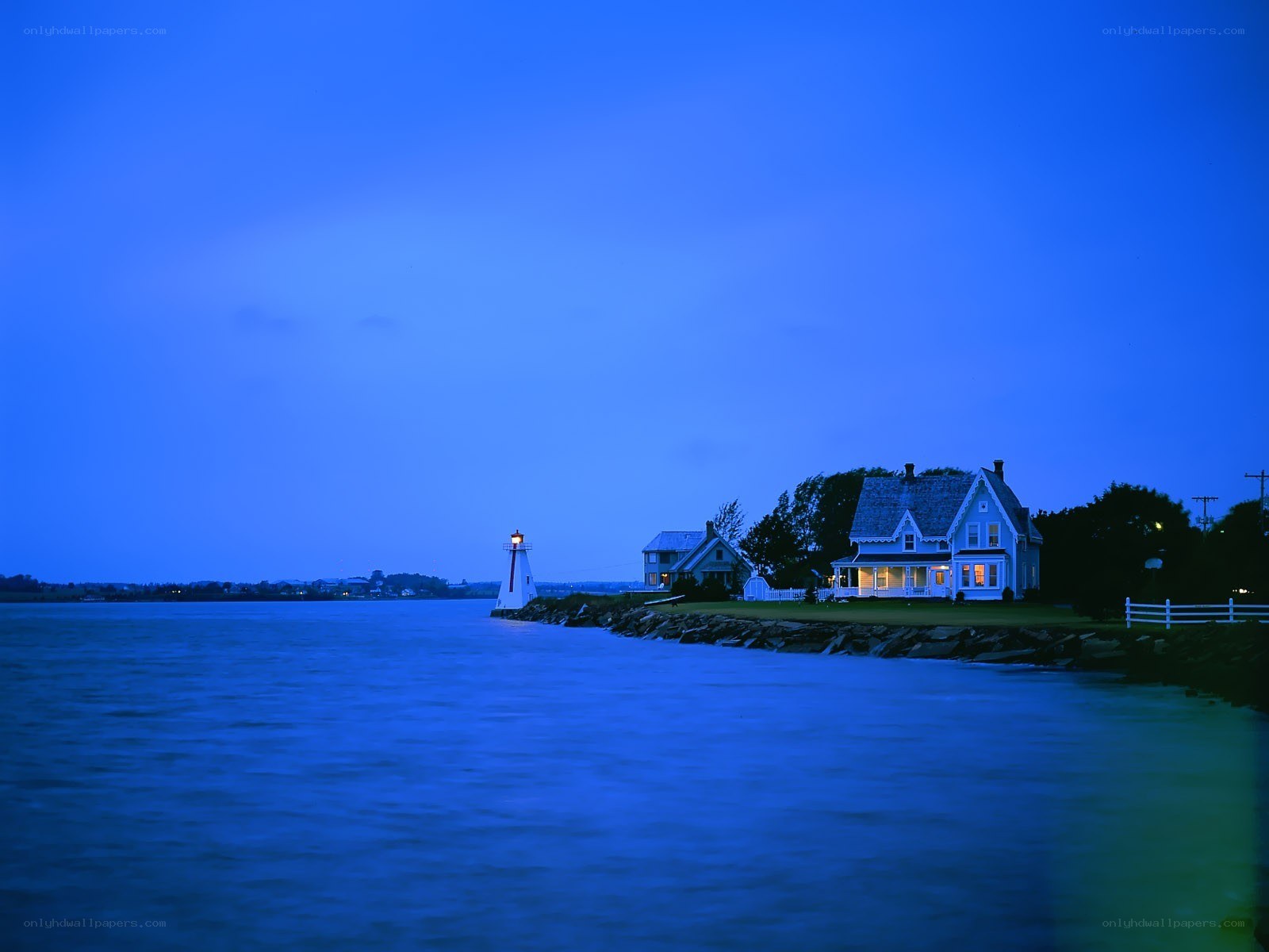Lighthouse at dusk by the water