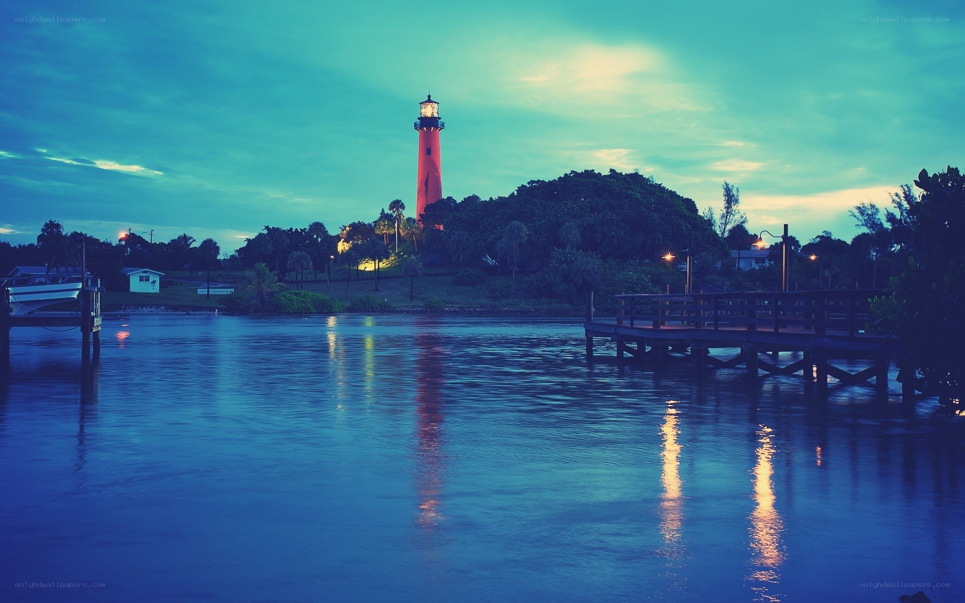 lighthouse at dusk by the water