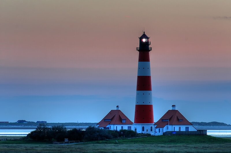Lighthouse at dusk on a coastal island