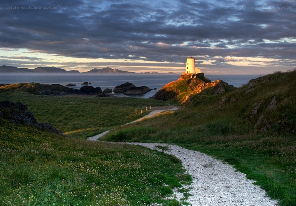 Lighthouse at dusk on a coastal path