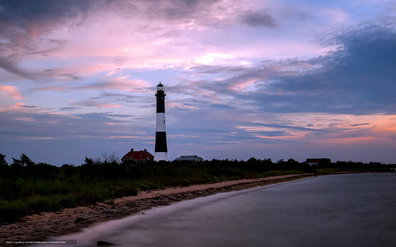 Lighthouse at dusk on a coastal shore