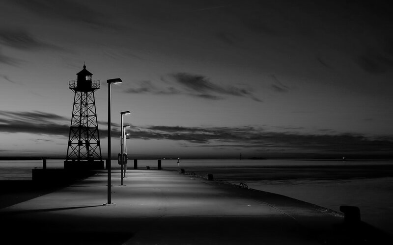 Lighthouse at dusk on a pier