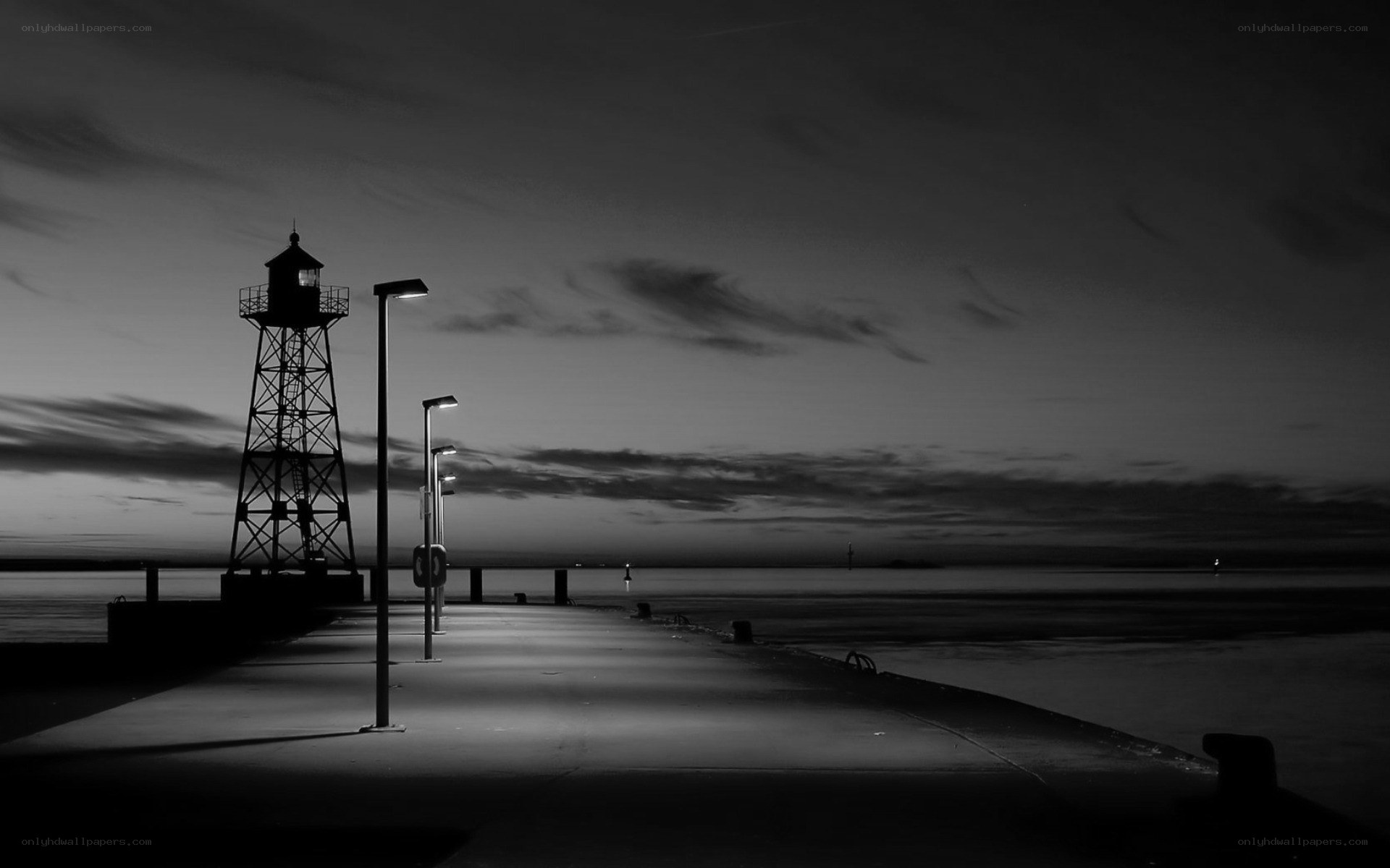 Lighthouse at dusk on a pier