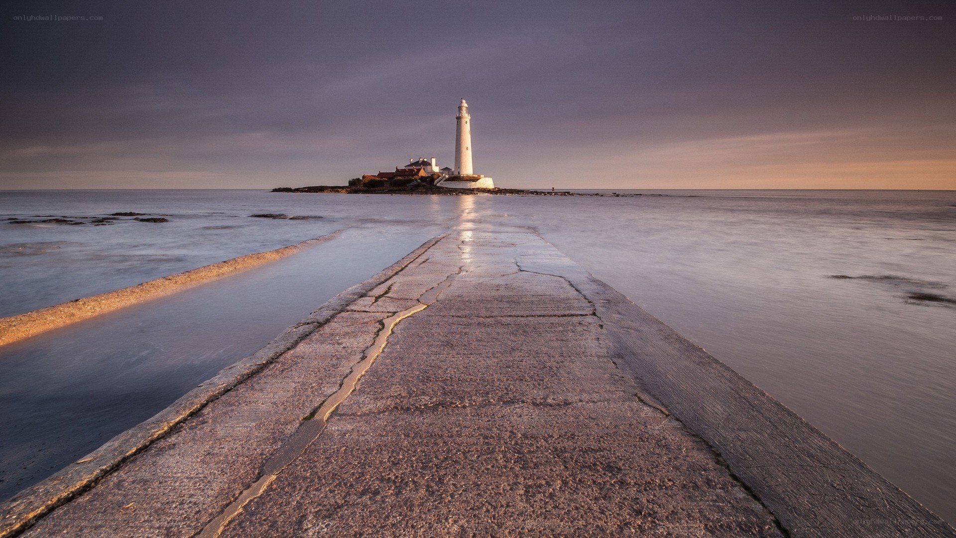 Lighthouse at dusk on a pier