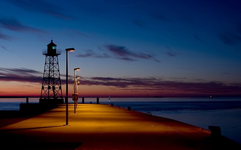 Lighthouse at dusk on a pier