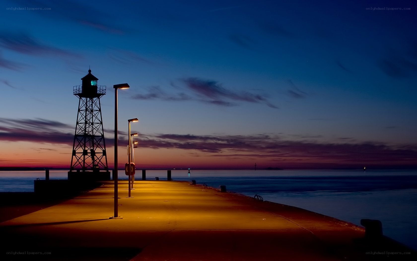 Lighthouse at dusk on a pier