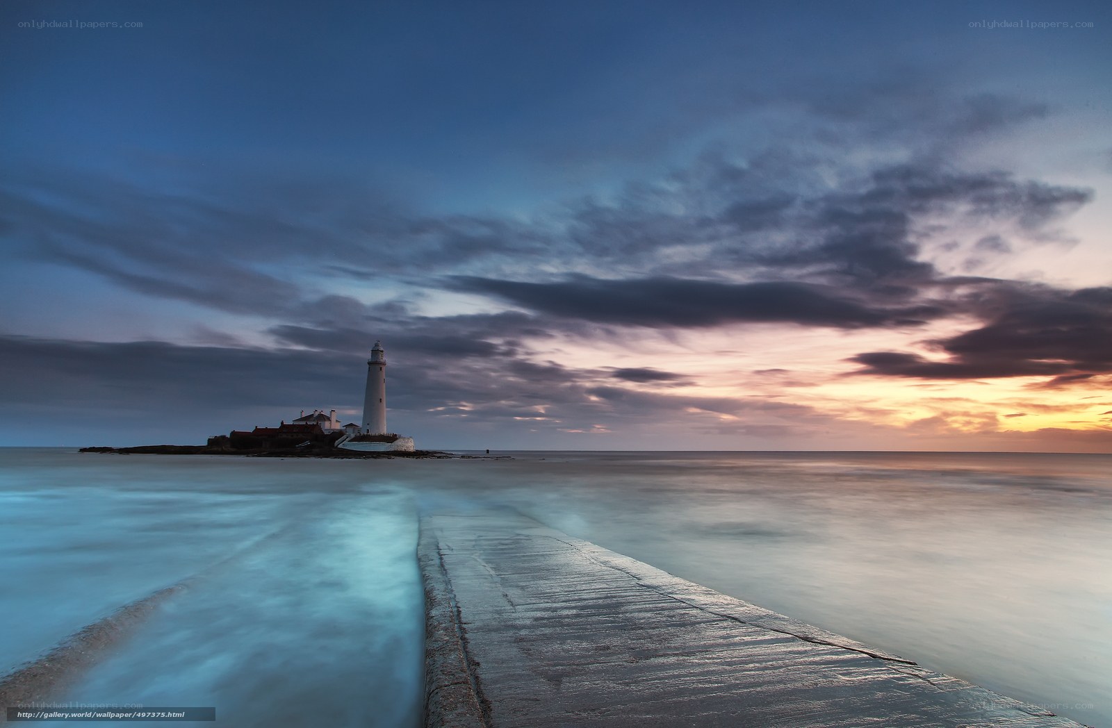 Lighthouse at dusk on a pier