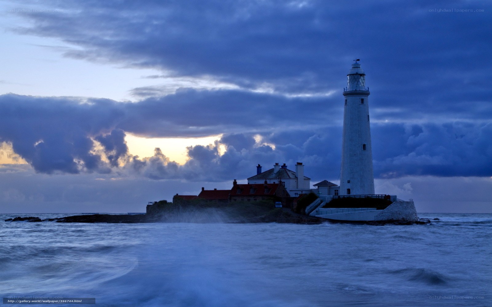 Lighthouse at dusk on a rocky island