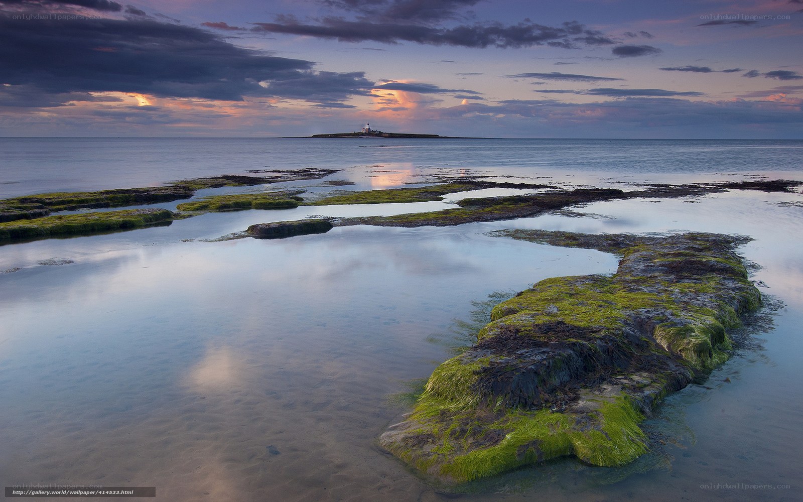 Lighthouse at Dusk on a Rocky Shore