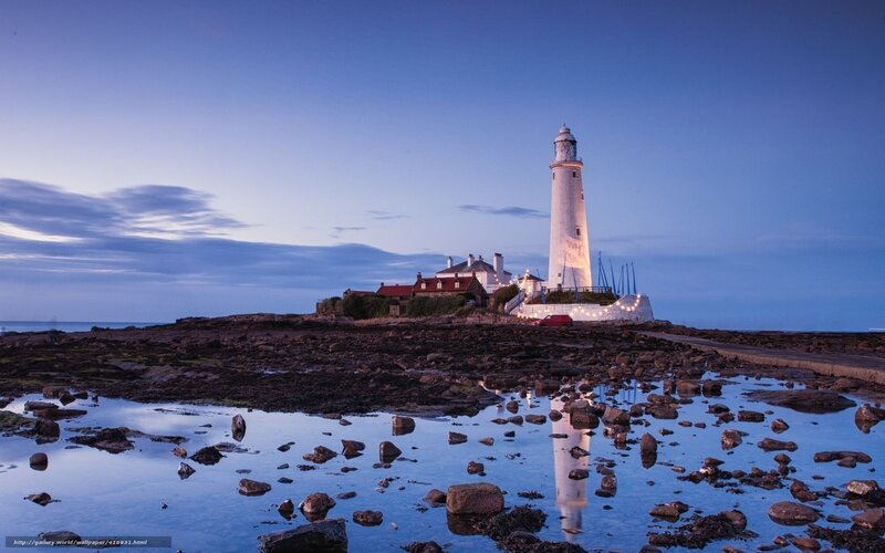 lighthouse at dusk on rocky shore