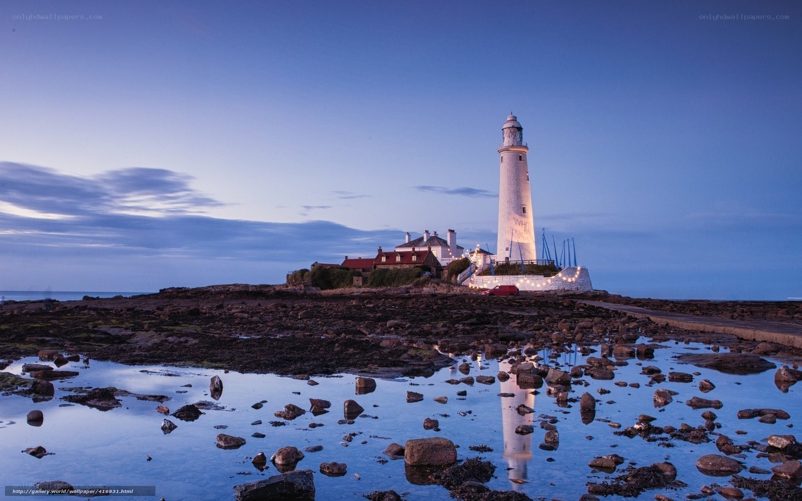 lighthouse at dusk on rocky shore