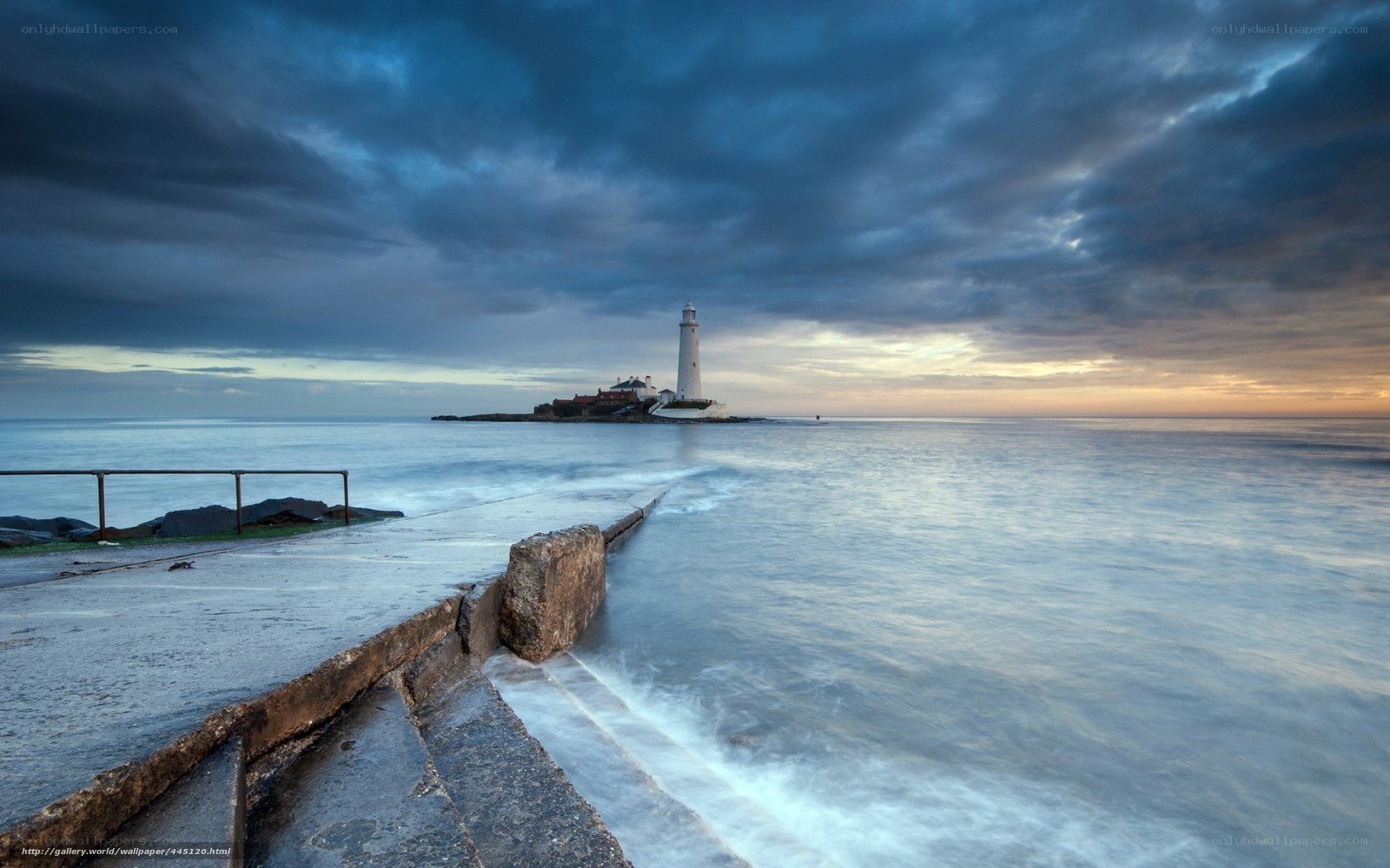 Lighthouse at dusk on rocky shore