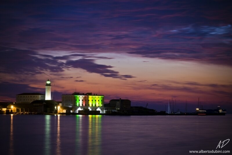 Lighthouse at dusk with colorful lights