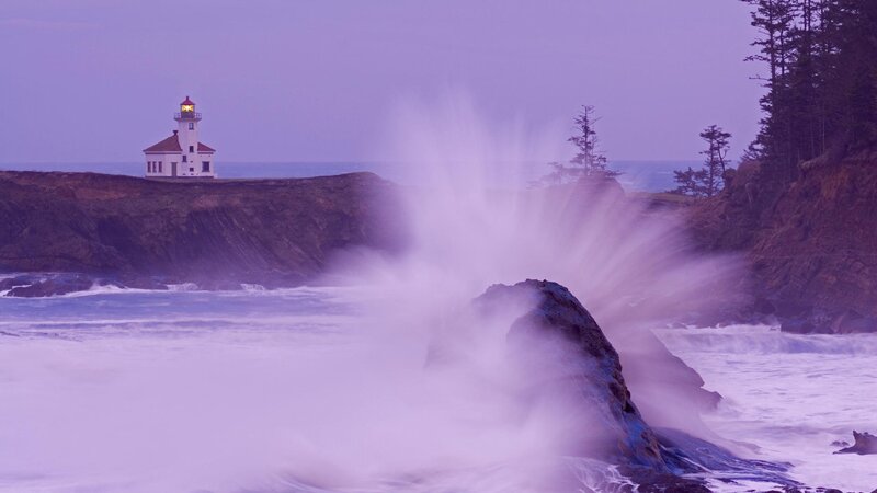 lighthouse at dusk with crashing waves