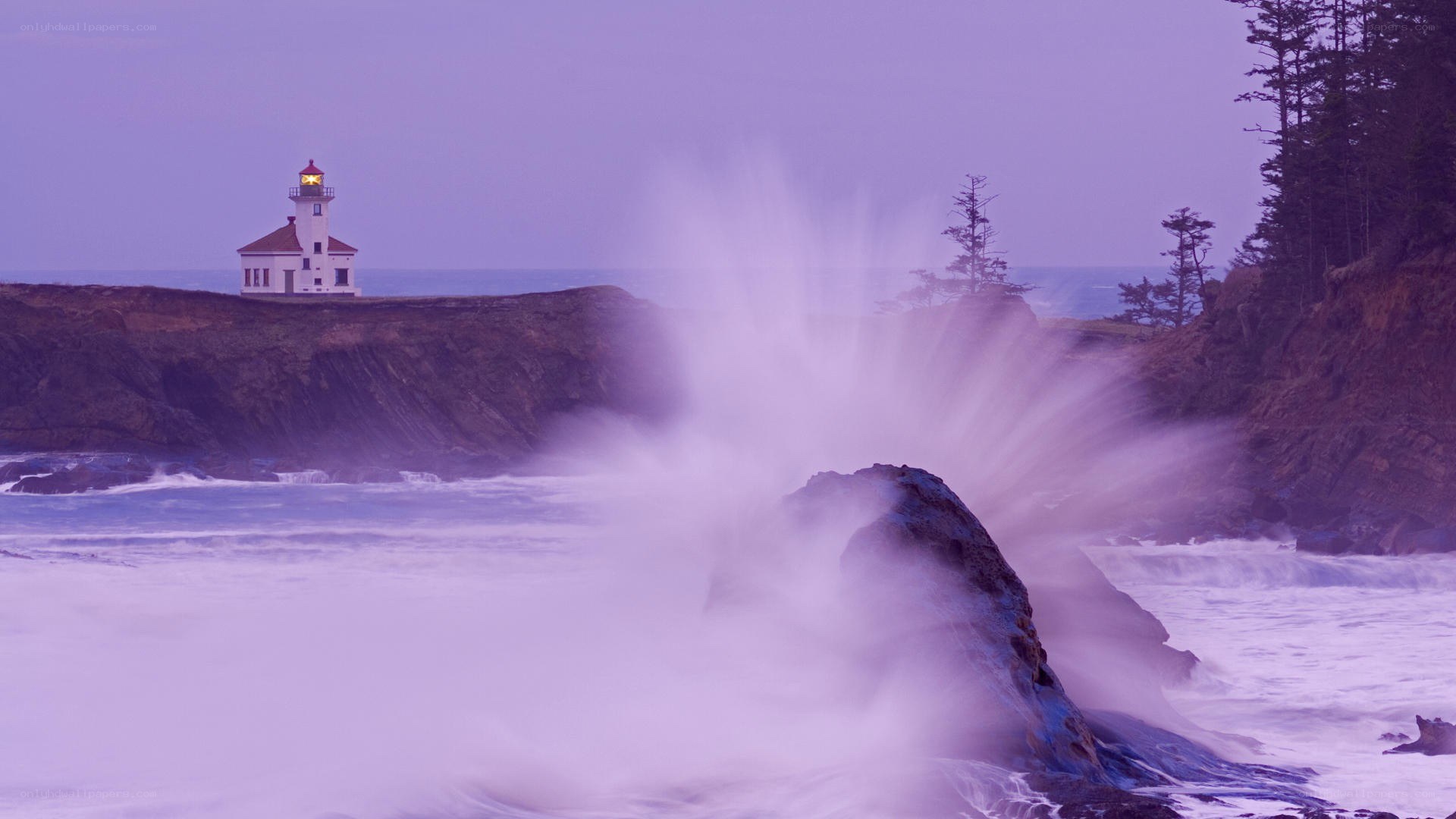 lighthouse at dusk with crashing waves