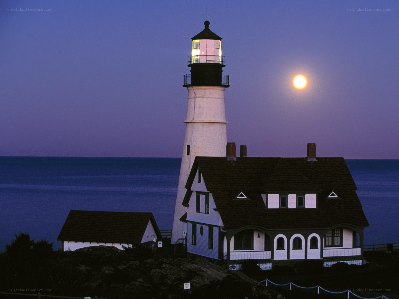 Lighthouse at dusk with full moon