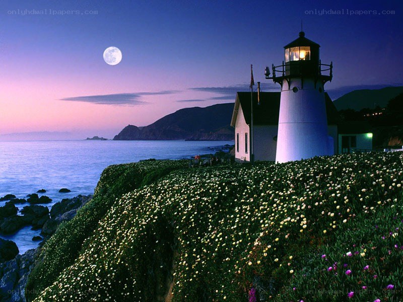 Lighthouse at dusk with full moon