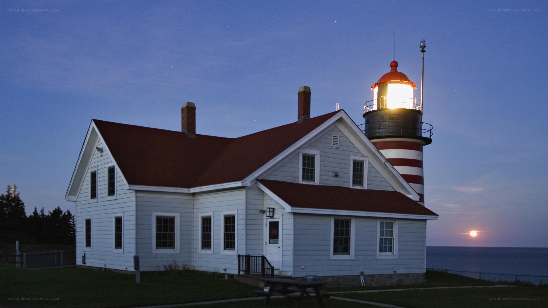 lighthouse at dusk with moonrise