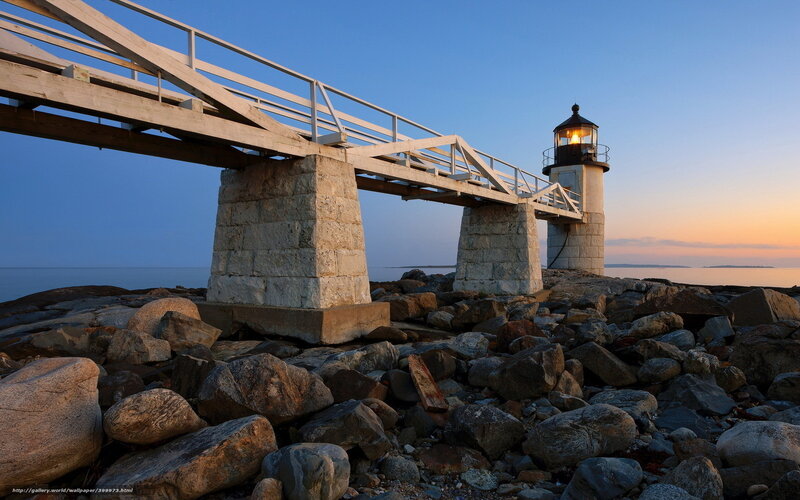 Lighthouse at dusk with stone pier