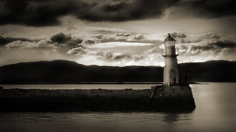 Lighthouse at dusk with stormy sky