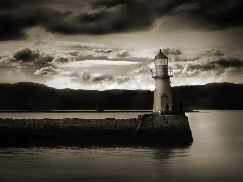 Lighthouse at dusk with stormy sky