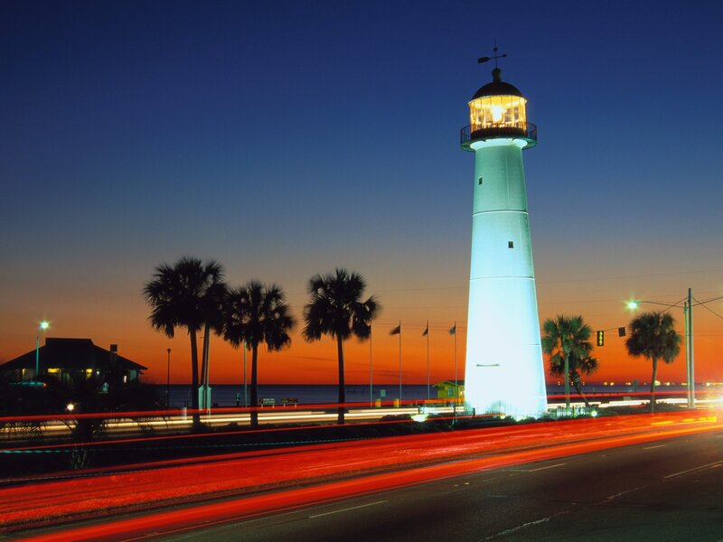 lighthouse at dusk with traffic