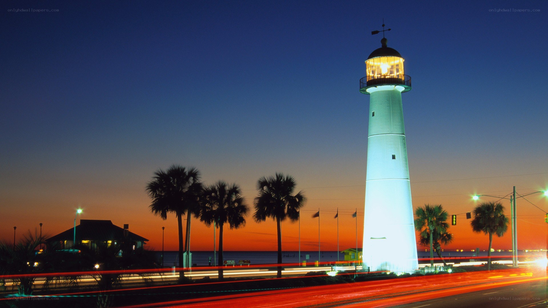 lighthouse at dusk with traffic