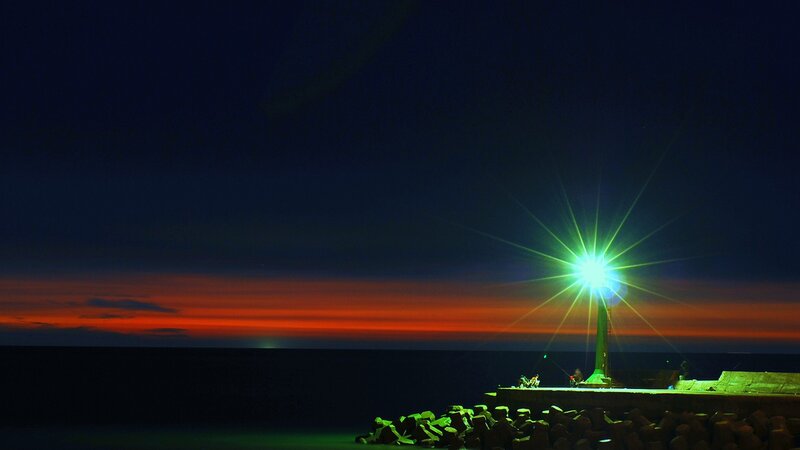 Lighthouse at dusk with vibrant sky