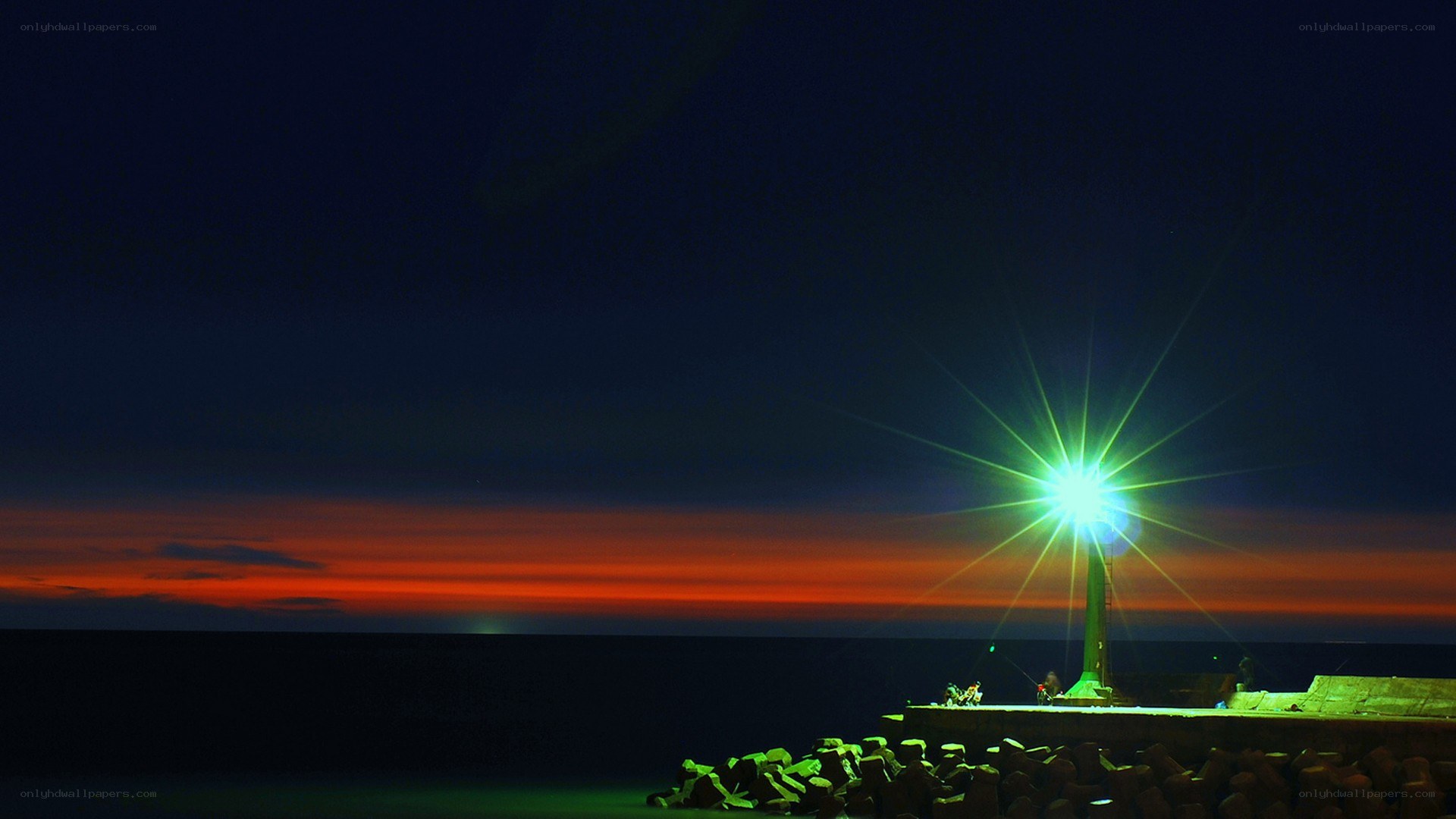 Lighthouse at dusk with vibrant sky