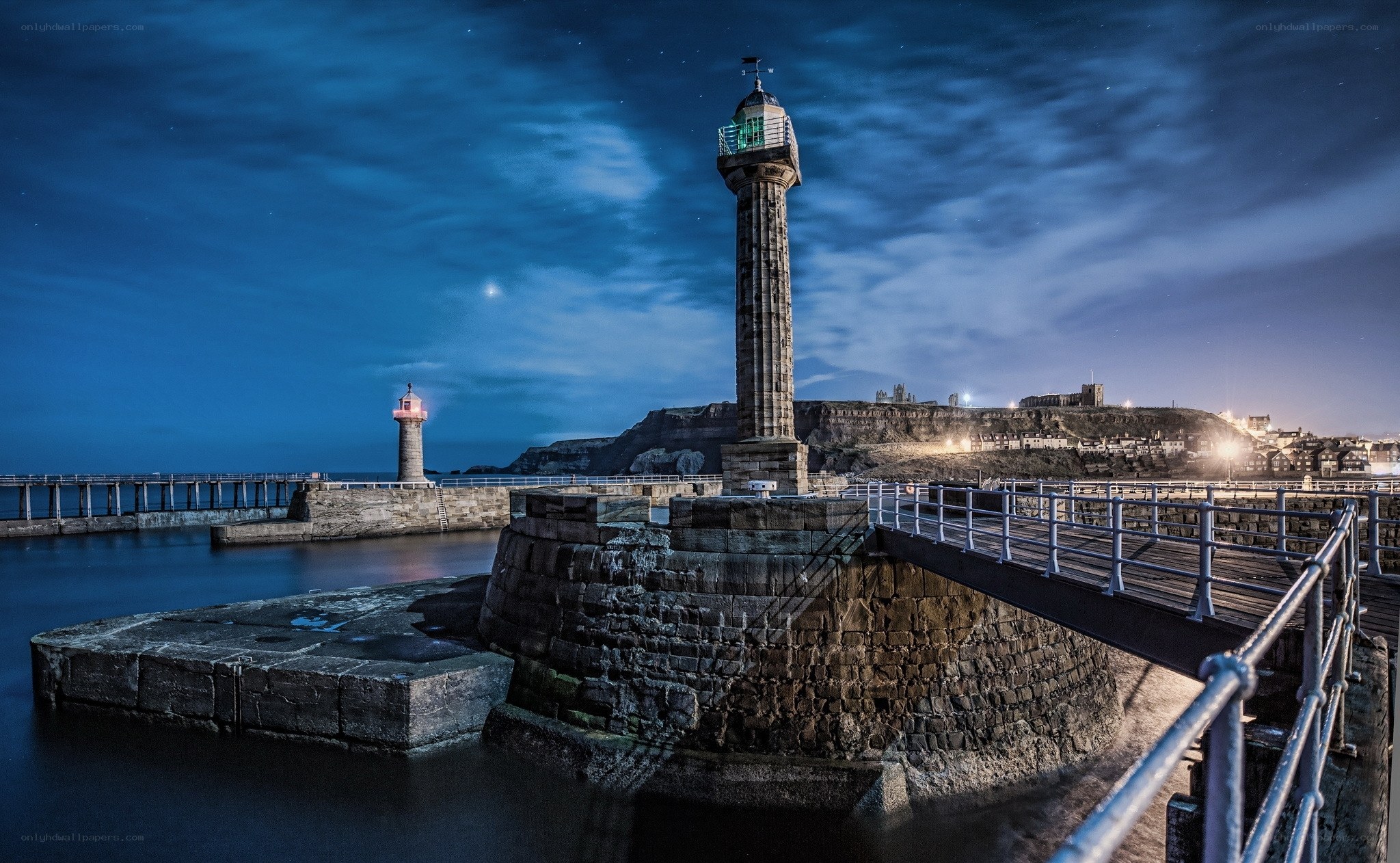 Lighthouse at night in a harbor
