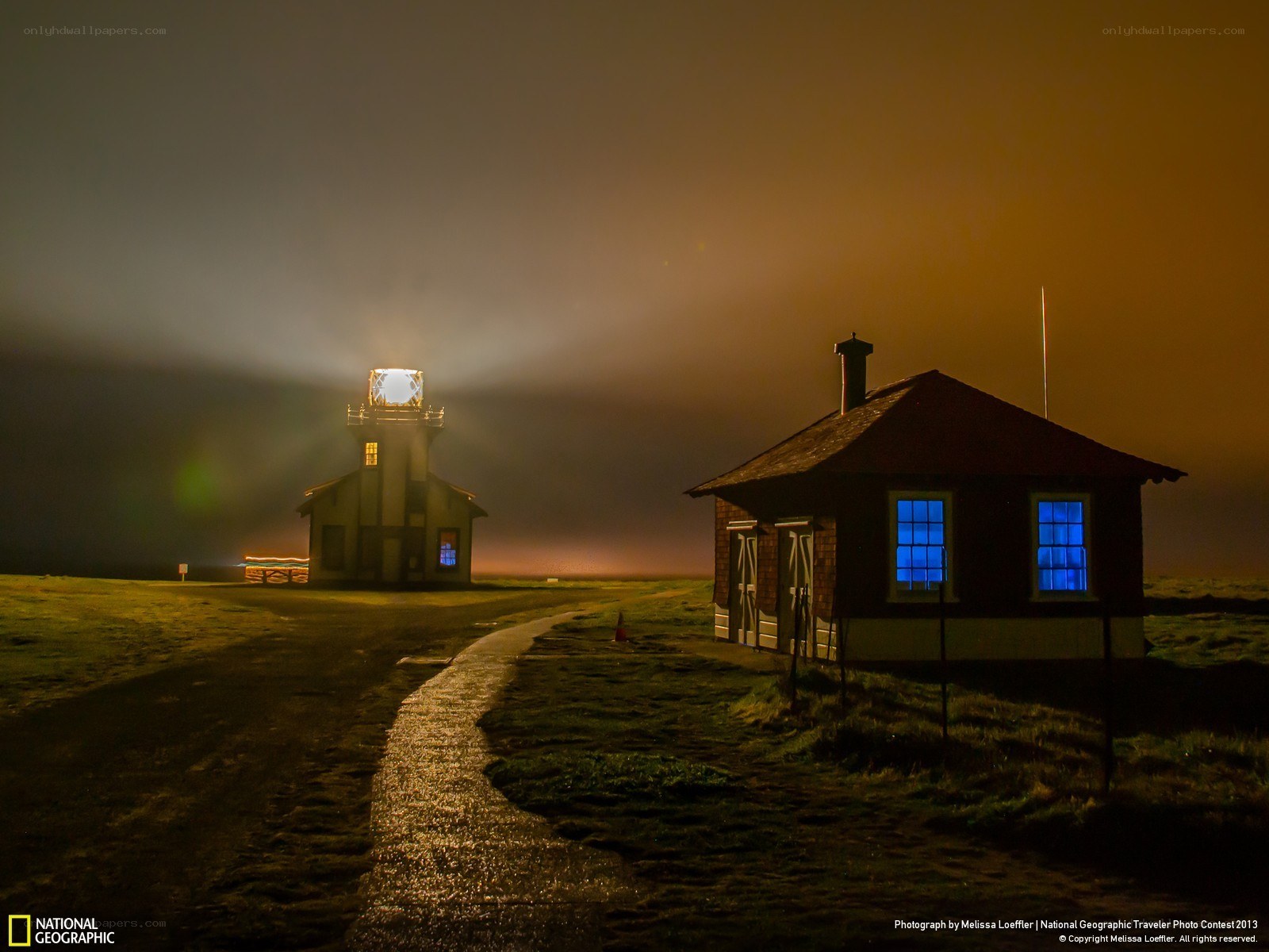 Lighthouse at night in fog