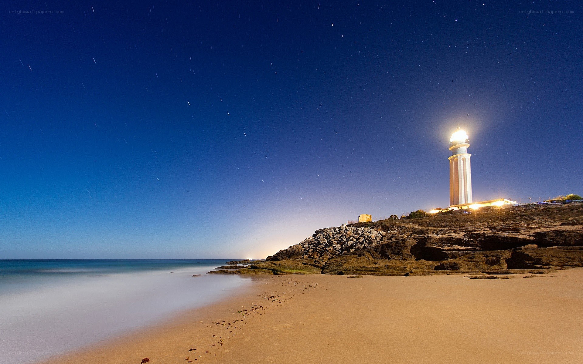 Lighthouse at night on a beach