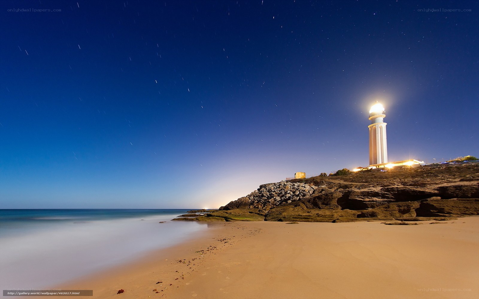 Lighthouse at night on a beach