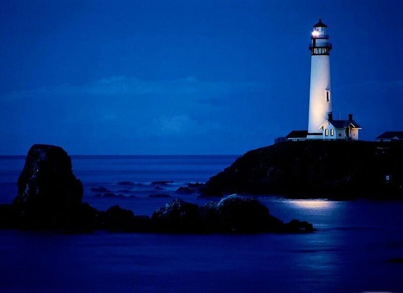 lighthouse at night on rocky coast